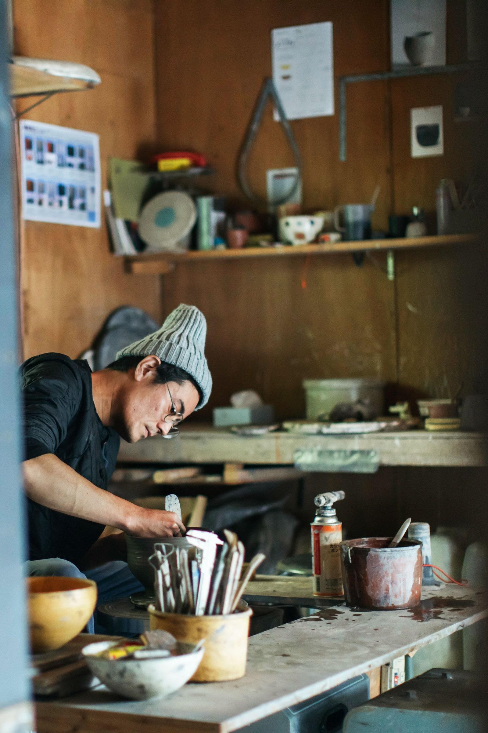 A potter at work at Community Store To See